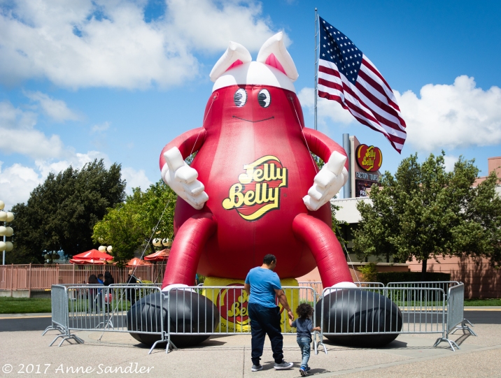 A dad and daughter gaze at the giant jelly bean outside the entry.